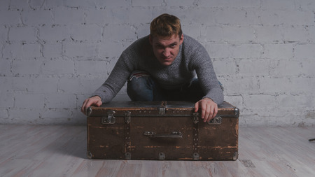 The guy with the suitcase, vacation package. Huge suitcase. Concept: vacation and vacation.の写真素材