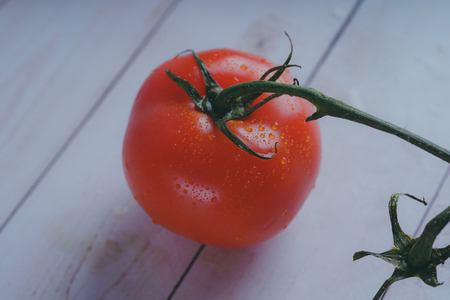 Red tomato on wooden background, concept: fresh vegetables, healthy food.の写真素材