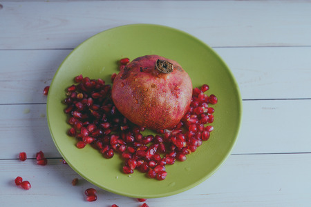 Red pomegranate wooden background, concept: fresh vegetables, healthy food.の写真素材