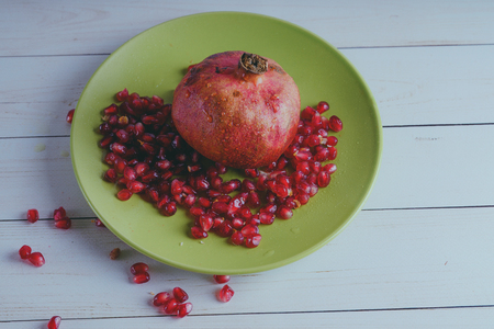 Red pomegranate wooden background, concept: fresh vegetables, healthy food.の写真素材