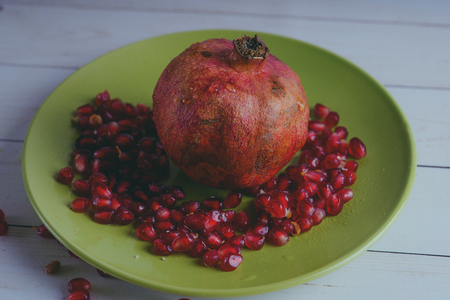 Red pomegranate wooden background, concept: fresh vegetables, healthy food.の写真素材