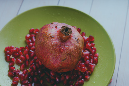 Red pomegranate wooden background, concept: fresh vegetables, healthy food.の写真素材