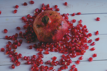 Red pomegranate wooden background, concept: fresh vegetables, healthy food.の写真素材
