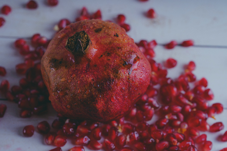 Red pomegranate wooden background, concept: fresh vegetables, healthy food.の写真素材