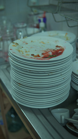Lots of dirty dishes, after co-op or banquets. The concept of dirty cuisine in the restaurant.の写真素材