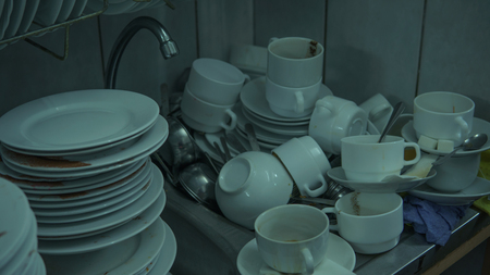 Lots of dirty dishes, after co-op or banquets. The concept of dirty cuisine in the restaurant.の写真素材