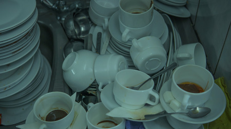 Lots of dirty dishes, after co-op or banquets. The concept of dirty cuisine in the restaurant.の写真素材