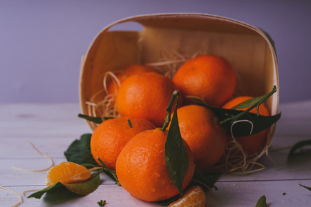 Fresh tangerines on a wooden background. Mandarins with copy space for text. Ripe and tasty tangerines. Clementines on a wooden table. Background tangerines.の写真素材