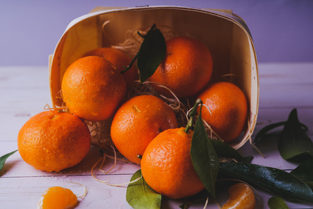 Fresh tangerines on a wooden background. Mandarins with copy space for text. Ripe and tasty tangerines. Clementines on a wooden table. Background tangerines.の写真素材