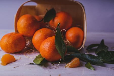 Fresh tangerines on a wooden background. Mandarins with copy space for text. Ripe and tasty tangerines. Clementines on a wooden table. Background tangerines.の写真素材