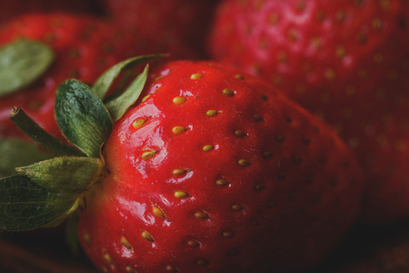 Fresh strawberries in a clay plate. Fresh berries on the table. Red strawberries in a brown bowl. Fruit close-upの写真素材
