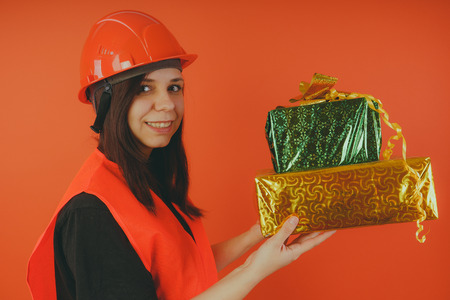 Girl Builder with cashback, presents with the concept of cashback, gift with purchase or discount. Loader or builderの写真素材