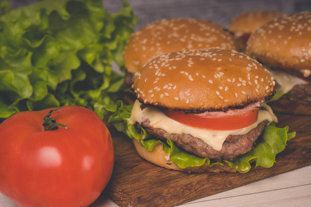 ?amburger or sandwich on brown paper. Delicious sandwich hamburger with meat, cheese and fresh vegetable. Hamburger or sandwich Juicy cheeseburgerの写真素材