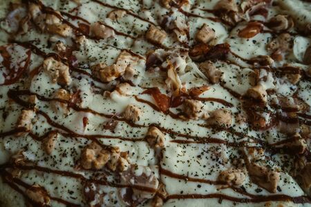 texture of pizza, close-up. Thin slices of sausage. Texture of hot traditional italian dish.