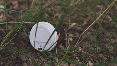 Garbage in the Park or forest, an empty glass lying on the ground. The concept of environmental pollution, environmental problems of nature.の写真素材