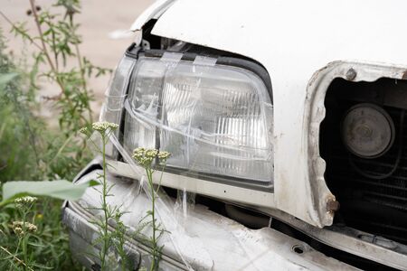 Abandoned rusty old car on roadの写真素材