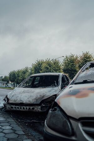 Vandalism or revenge, burnt car. The consequences of popular protest, burnt car, a crime. Car after fire. Auto trashの写真素材