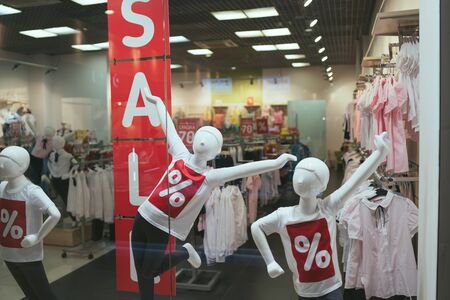 Season sale, black friday and shopping concept. Sale signs on stands in shop