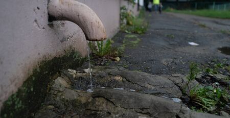 Roof gutter pipe line after rain with water drainage.の写真素材