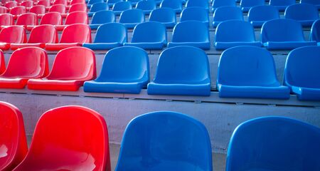 Bleachers in a sports stadium. Red and blue seats in a large street stadium.の写真素材