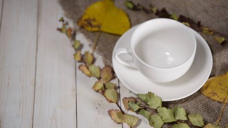 Cup of coffee with coffee beans on vintage wooden table. Homemade coffee or americano.の写真素材