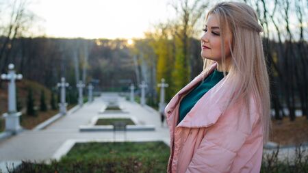 A portrait of a beautiful girl, walking in the autumn park.の写真素材