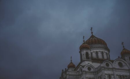 Golden domes of a Christian temple in Russia against the gray sky.の写真素材