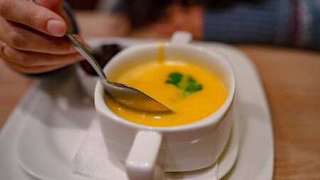Cheese cream soup on the table in the cafe.の写真素材