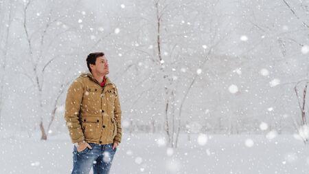 Portrait of young man in jacket and jeans in winter season.