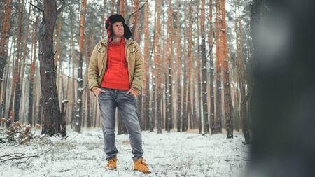 Man standing in forest in winter day.の写真素材
