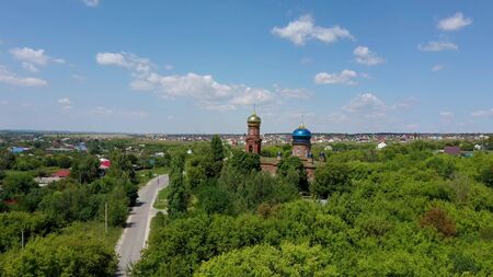 red brick christian church with golden domes