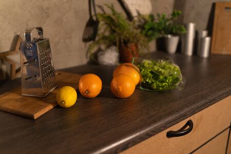 Modern domestic dark interior of kitchen cabinets with cookware.