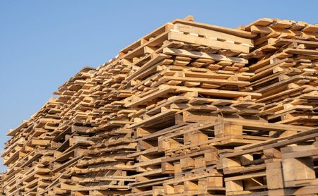 Used wooden pallets in stack in the warehouse. Wooden pallet overlap.の写真素材