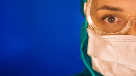 The concept of a coronavirus. Respiratory protection. A woman in a protective suit and a respiratorの写真素材