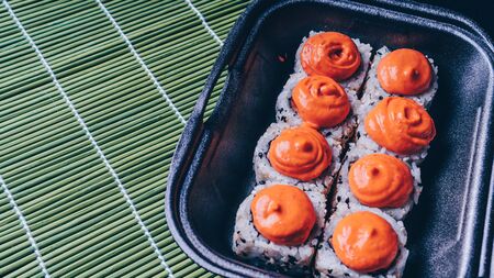 Sushi rolls mix in a plastic box container, set of delicious sushi rolls. Japanese food. Sushi menu. sushi rolls mix in a plastic box containerの写真素材