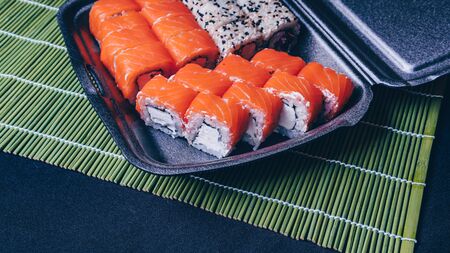 Sushi menu. sushi rolls mix in a plastic box containerの写真素材