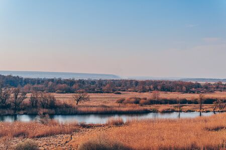 A quiet river in a green rural area. Beautiful landscape with a river with calm water, located next...