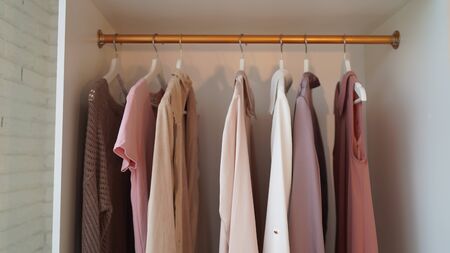 Close up of hangers with different clothes in wardrobeの写真素材