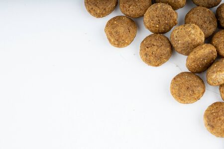 Dry food in right corner on white background. Close up of useful pet food. Concept of space for your...