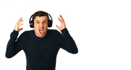 Crazy man in headphones isolated on a white background. Concept of the international day of music.