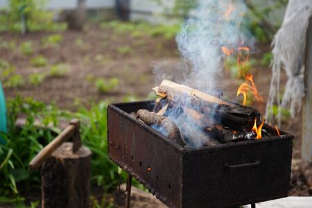 Close up of fire on chargrill. Dry sticks smoulder.の写真素材