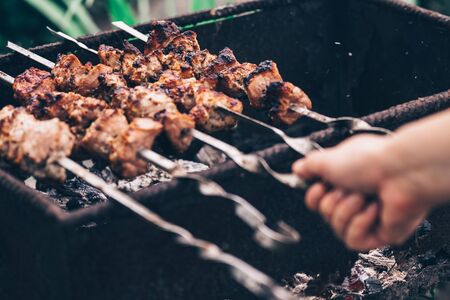 Close up of toasted shashlik on skewers. Succulent barbecue roasting on chargrill.の写真素材