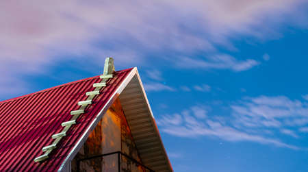 Close up of roof of house on background of dawn