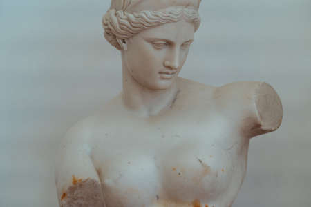 Old statue of Greek goddess made of marble and placed in historical museum on white backgroundの写真素材