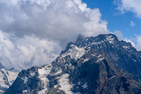 The rocky mountains were shrouded in clouds on a Sunny day.の写真素材