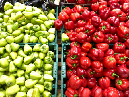 Ripe red and green peppers in a box. Fresh bell peppers in a box.の写真素材