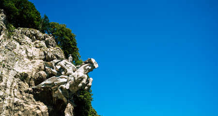 Monument wasgergi in the rock. Monument rider on a horse, equestrian statue on a rock.の写真素材