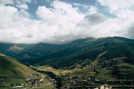 Mountain peaks against cloudy sky. Peaks of magnificent rocks located against bright cloudy sky.の写真素材