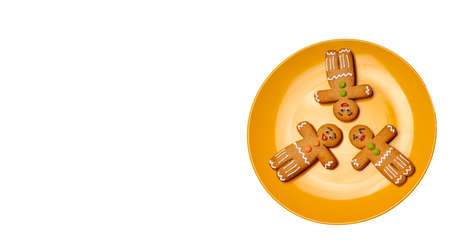 Close up of gingerbread men on isolated white background. Festive decorative gingerbreads for...