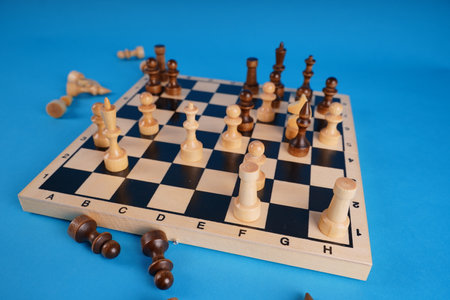 Close-up of chess on a blue background. Wooden chess pieces. Concept: the Board game and the...